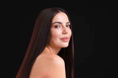Photo of Woman with beautiful smooth hair after lamination procedure on black background, space for text
