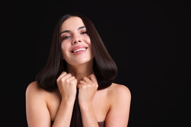 Photo of Woman with beautiful smooth hair after lamination procedure on black background, space for text