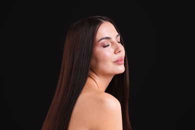 Photo of Woman with beautiful smooth hair after lamination procedure on black background