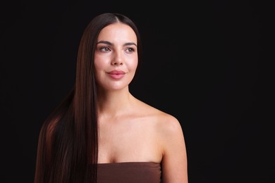 Photo of Woman with beautiful smooth hair after lamination procedure on black background