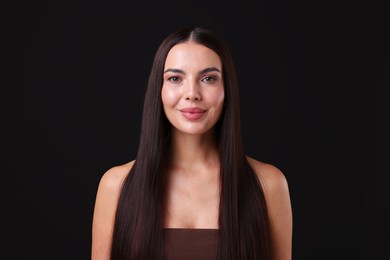 Photo of Woman with beautiful smooth hair after lamination procedure on black background