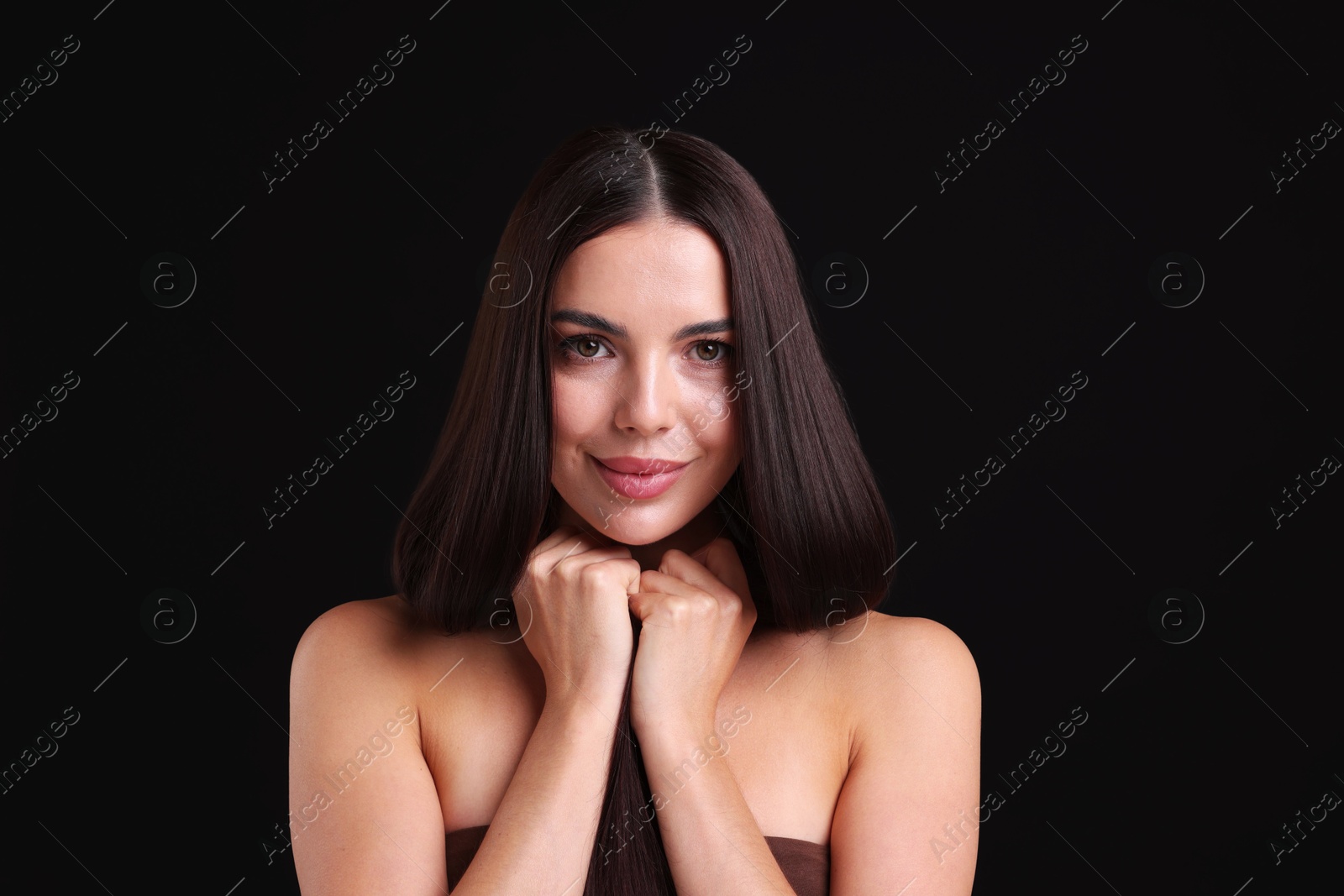 Photo of Woman with beautiful smooth hair after lamination procedure on black background
