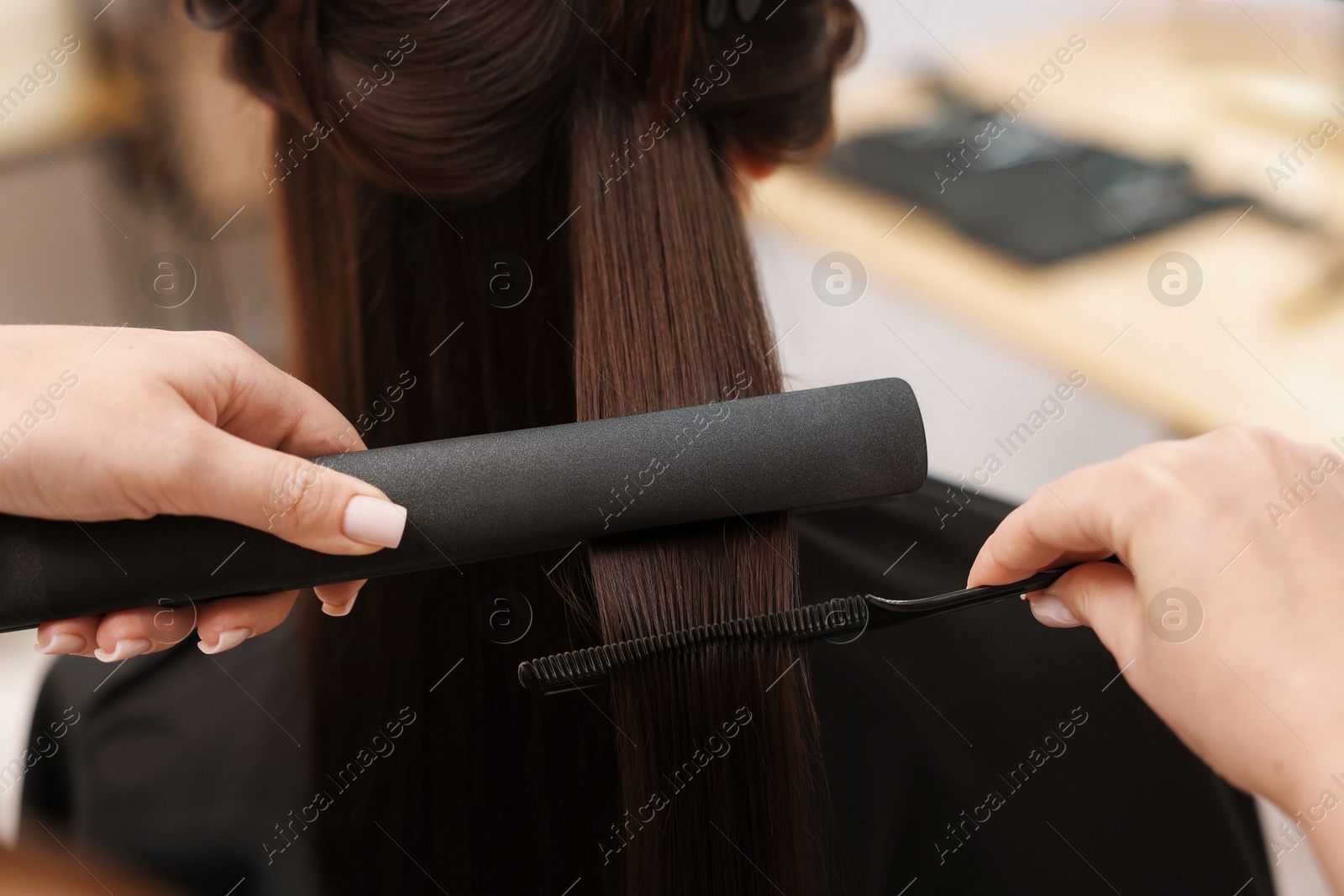 Hairdresser laminating woman's hair in salon, closeup Photo of Hairdresser laminating woman's hair in salon, closeup