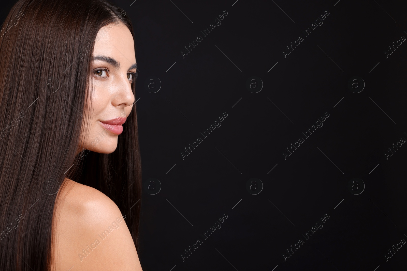 Woman with beautiful smooth hair after lamination procedure on black background, space for text Photo of Woman with beautiful smooth hair after lamination procedure on black background, space for text