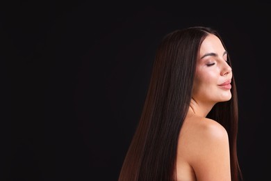 Photo of Woman with beautiful smooth hair after lamination procedure on black background, space for text