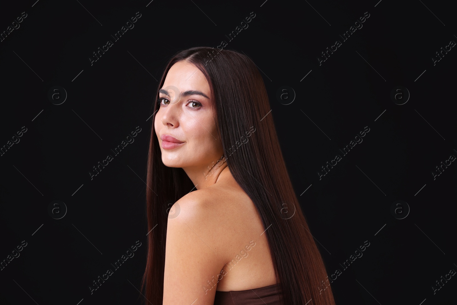 Woman with beautiful smooth hair after lamination procedure on black background Photo of Woman with beautiful smooth hair after lamination procedure on black background