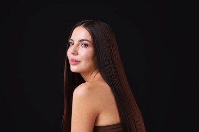 Photo of Woman with beautiful smooth hair after lamination procedure on black background