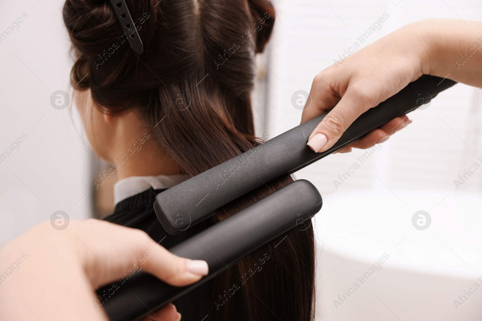 Hairdresser laminating woman's hair in salon, closeup Photo of Hairdresser laminating woman's hair in salon, closeup