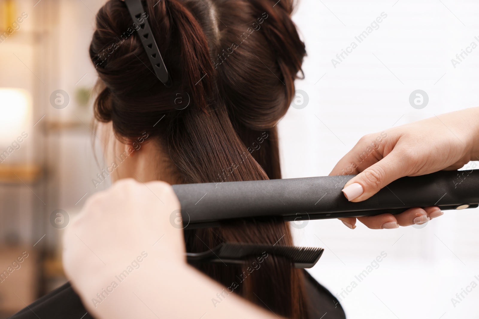 Hairdresser laminating woman's hair in salon, closeup Photo of Hairdresser laminating woman's hair in salon, closeup