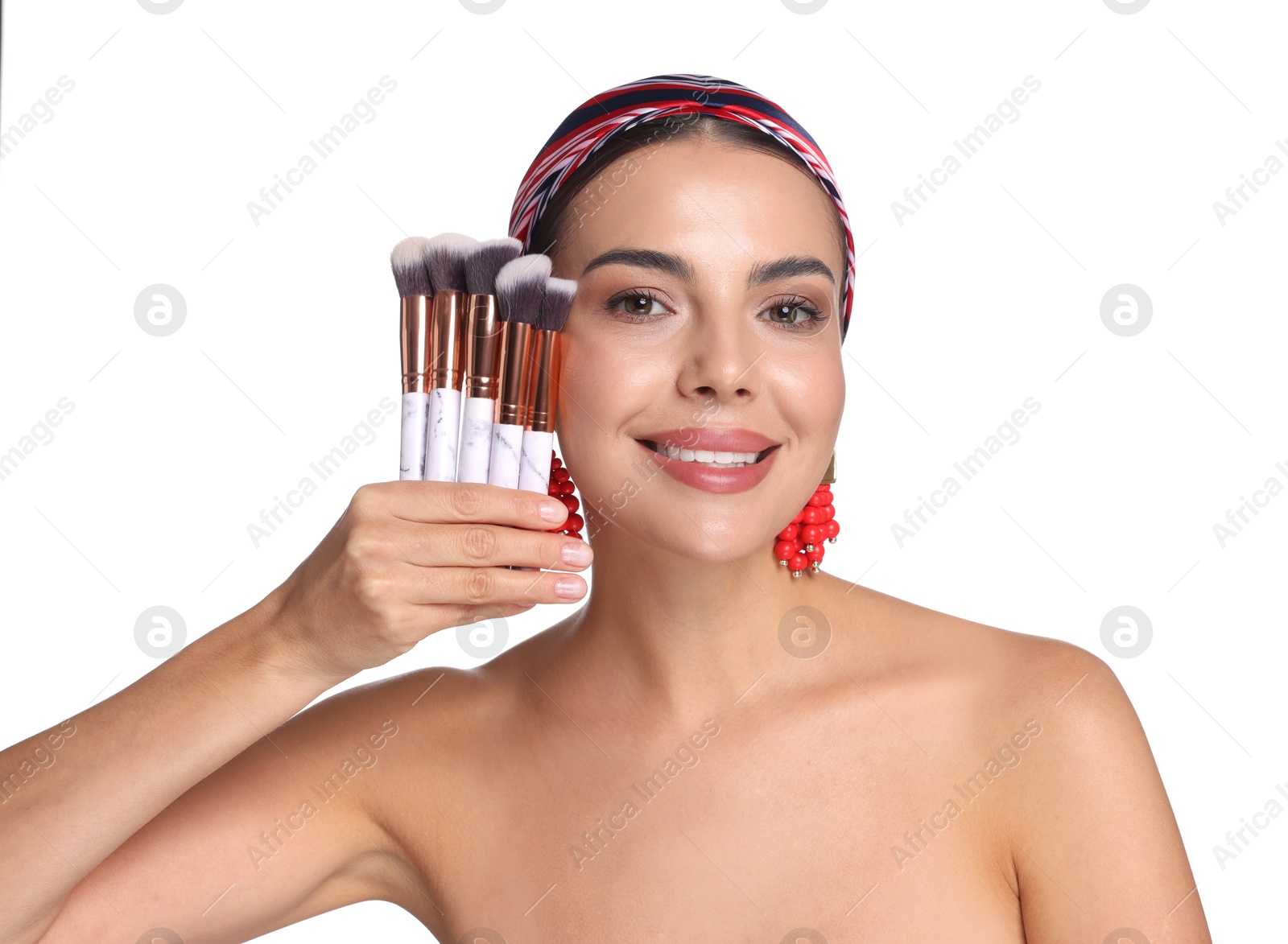 Photo of Beautiful woman with makeup brushes on white background