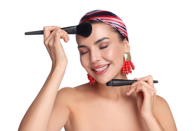 Photo of Beautiful woman with makeup brushes on white background