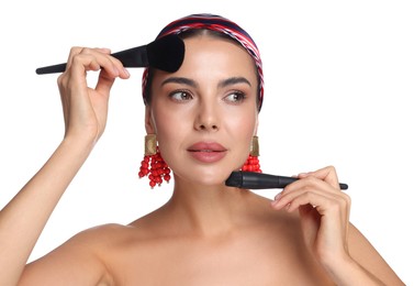 Photo of Beautiful woman with makeup brushes on white background