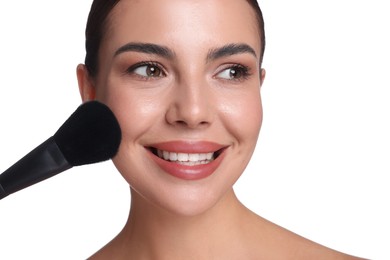 Photo of Beautiful woman applying makeup with brush on white background, closeup