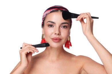 Photo of Beautiful woman with makeup brushes on white background