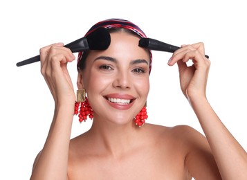 Photo of Beautiful woman with makeup brushes on white background