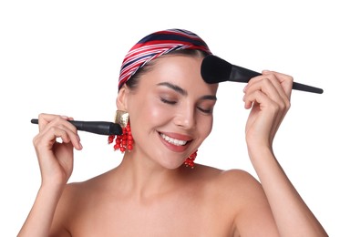 Photo of Beautiful woman with makeup brushes on white background