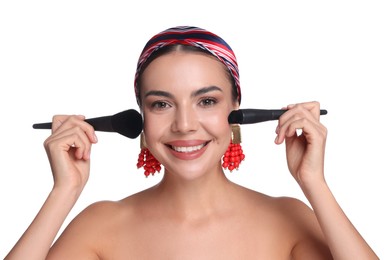 Photo of Beautiful woman with makeup brushes on white background