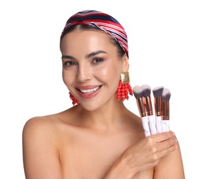 Photo of Beautiful woman with makeup brushes on white background