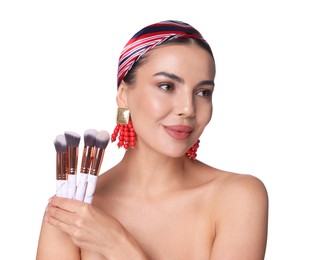 Photo of Beautiful woman with makeup brushes on white background