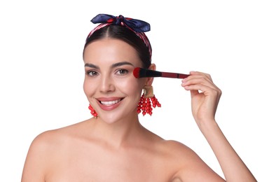 Photo of Beautiful woman applying makeup with brush on white background