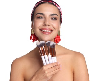 Photo of Beautiful woman with makeup brushes on white background