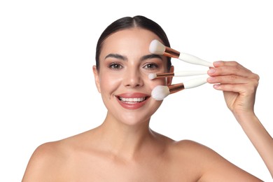 Photo of Beautiful woman with makeup brushes on white background