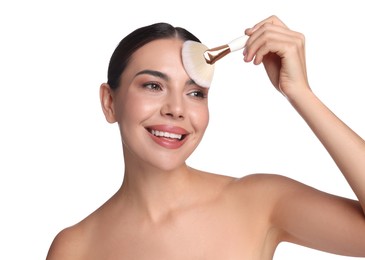 Photo of Beautiful woman applying makeup with brush on white background
