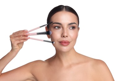 Photo of Beautiful woman with makeup brushes on white background