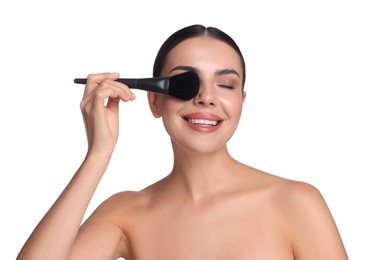 Photo of Beautiful woman applying makeup with brush on white background