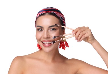 Photo of Beautiful woman with makeup brushes on white background
