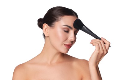 Photo of Beautiful woman applying makeup with brush on white background