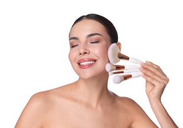 Photo of Beautiful woman with makeup brushes on white background