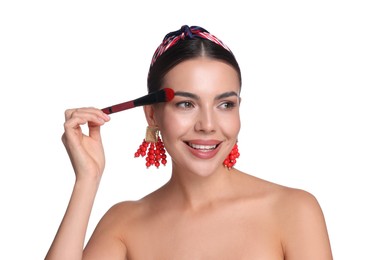 Photo of Beautiful woman applying makeup with brush on white background