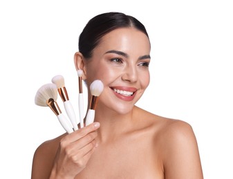 Photo of Beautiful woman with makeup brushes on white background