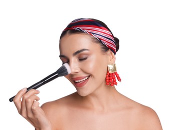 Photo of Beautiful woman applying makeup with brush on white background