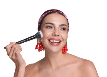 Photo of Beautiful woman applying makeup with brush on white background