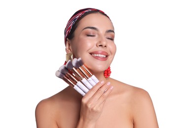 Photo of Beautiful woman with makeup brushes on white background
