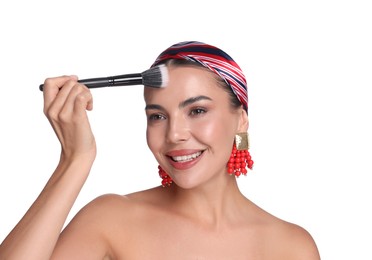 Photo of Beautiful woman applying makeup with brush on white background