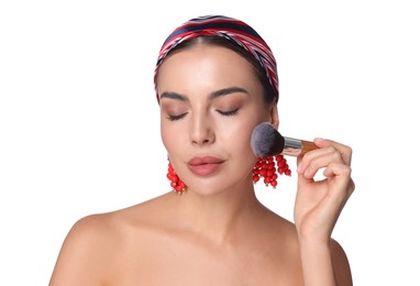 Photo of Beautiful woman applying makeup with brush on white background