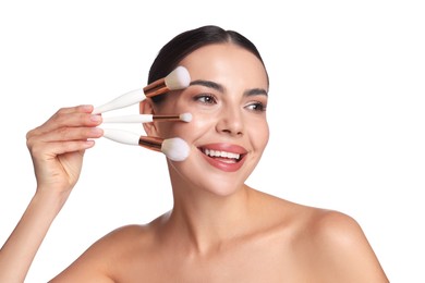 Photo of Beautiful woman with makeup brushes on white background