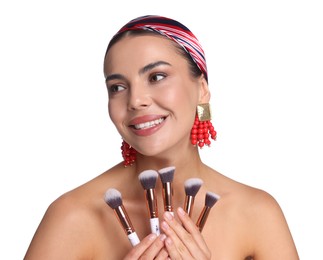 Photo of Beautiful woman with makeup brushes on white background