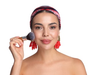 Photo of Beautiful woman applying makeup with brush on white background