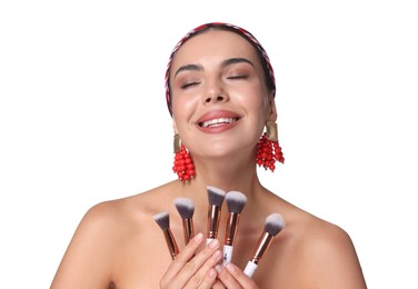 Photo of Beautiful woman with makeup brushes on white background