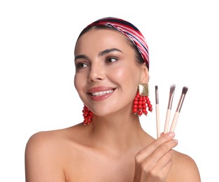 Photo of Beautiful woman with makeup brushes on white background