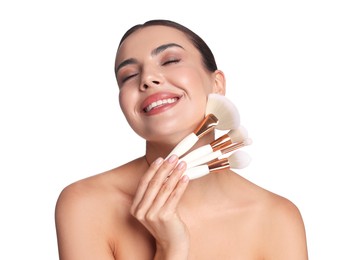 Photo of Beautiful woman with makeup brushes on white background