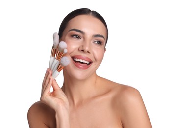 Photo of Beautiful woman with makeup brushes on white background