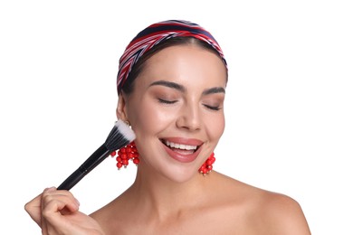 Photo of Beautiful woman applying makeup with brush on white background