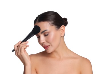 Photo of Beautiful woman applying makeup with brush on white background
