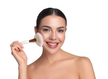 Photo of Beautiful woman applying makeup with brush on white background