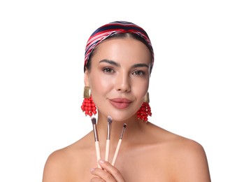 Photo of Beautiful woman with makeup brushes on white background